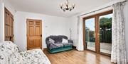 Image of living room with doors that open into kitchen