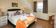 Dark Hedges Bedroom with a double bed, chair and a window.