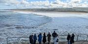 Discover Portrush Walking Tours group shot in front of Portrush East Strand