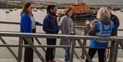 Discover Portrush Walking Tours in front of Portrush lifeboat