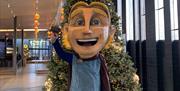 Finn McCool in front of the Christmas Tree within the Giant's Causeway