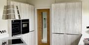 kitchen showing modern units and appliances