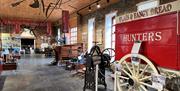 Image of the inside of the museum - with artifacts including a bread cart which would have been pulled by a horse