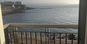 Image of doors open onto juliette balcony with sea view and onto Portstewart Promenade with vehicle