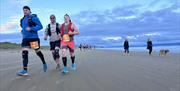 Giants Causeway Coast Marathon runners on beach