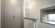 Causeway Squarings entrance door at top of staircase  with small window.
