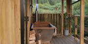 Image of the outdoor, wood fired bath on the veranda of the cabin