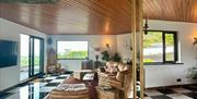 The Loft, the open-plan living room at The Brass Goat, looking out over the glen