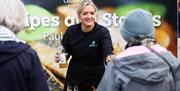 A lady holding a bottle at the local food tastings