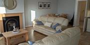 Living area with fireplace and dining table behind