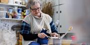 Patricia Millar working on a ceramic piece in her workshop.