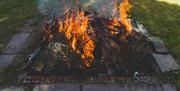 an earthen pit of flames used for firing pottery