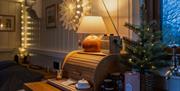Cosy Christmas scene in hut interior showing warm lights and mini Christmas tree