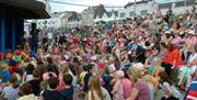 a large crowd of people watching a performance at The Crescent in Portstewart