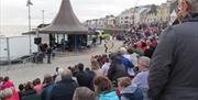 a large crowd of people watching a performance at The Crescent in Portstewart