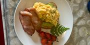 bacon and scrambled eggs on top of avocodo toast at Dromore House