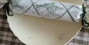 a christmas cracker wrapped in printed linen