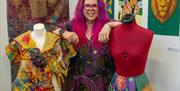Yolande Shannon alongside some of her clothes designs.