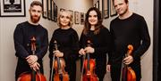 the archo string quartet with their instruments