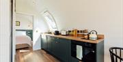 living kitchen area through to bedroom