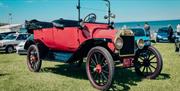 An old red vehicle with its top down