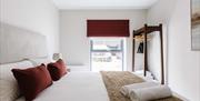 interior of bedroom at DB Stays 'The Cove' featuring a double bed and standalone clothes wrack