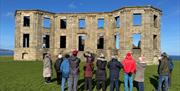 a group enjoy a tour on the grounds of Downhill Demesne