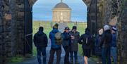 a group enjoy a tour on the grounds of Downhill Demesne