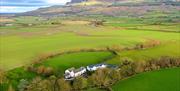 Aerial view of The Willows estate surrounded by green fields at the foot of Binevenagh Mountain near Limavady.