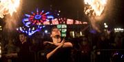 person performing with fire at a fairground