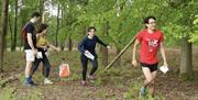 a group of people orienteering in the forest