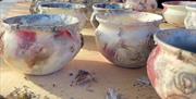 colourful ceramic pots featuring pink tones after the firing process