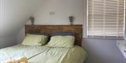 Superking sized bed with wall mounted dresser and mirror