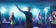 Irish dancers on stage backed by a live band
