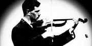 black and white image of Sam Henry playing the violin