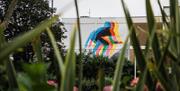 an abstract mural of a surfer on the side of a building