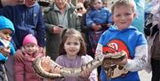 Children holding a snake