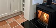 wood burning stove in kitchen area at Wrens Nest