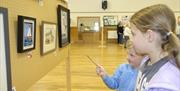 Children examining the exhibition space