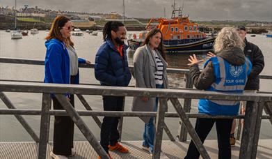Discover Portrush Walking Tours in front of Portrush lifeboat