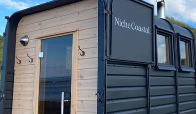 Close up of the back of the sauna, with the horsebox door open.