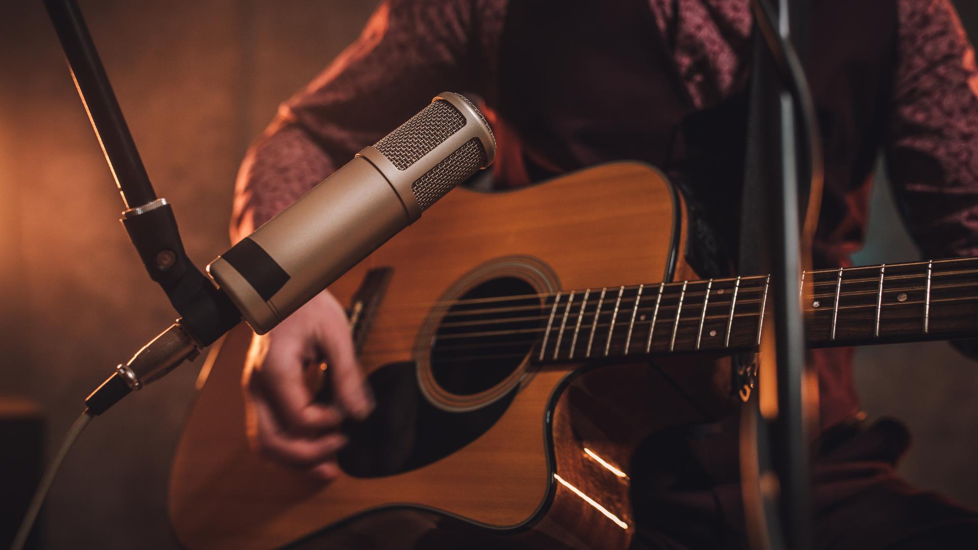 close up of acoustic guitar and microphone close up of acoustic guitar and microphone