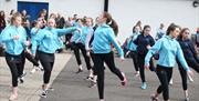 Dancers in blue jumpers entertaining the crowds in Castlecroft Square