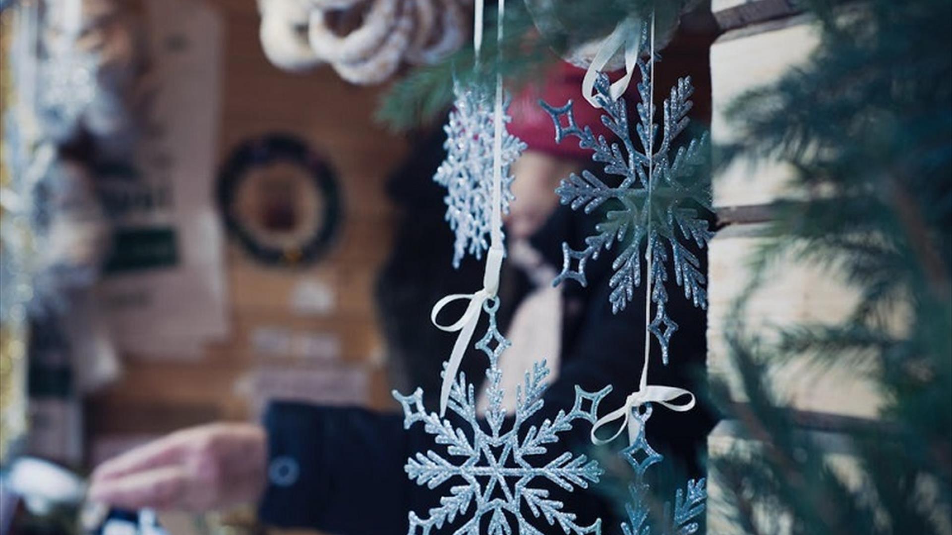 decorative snowflakes hang from a market stall decorative snowflakes hang from a market stall
