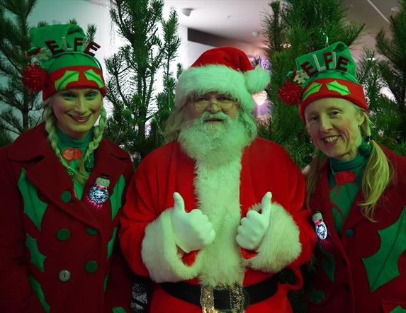 Santa on his elves ready to greet the children in the grotto