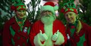 Santa on his elves ready to greet the children in the grotto