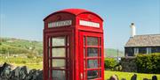 a red telephone box in the village of Cushendun