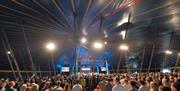 People attending New Horizon in the big blue tent