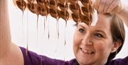Geri Martin taps out tempered chocolate at The Chocolate Manor