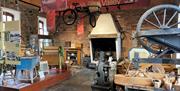 Image of the inside of the museum - with artifacts including a bicycle and a spinning wheel